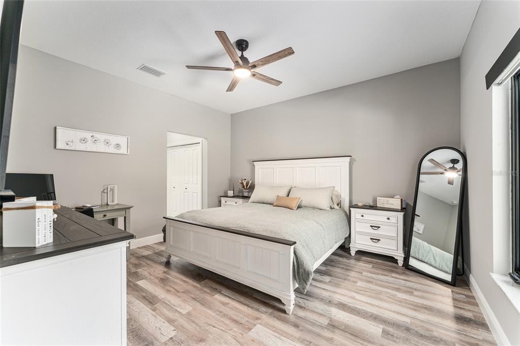 9 Middleground Road Ocala, FL 34482 - Photo 19 of 42 a bedroom with a bed and wooden floor