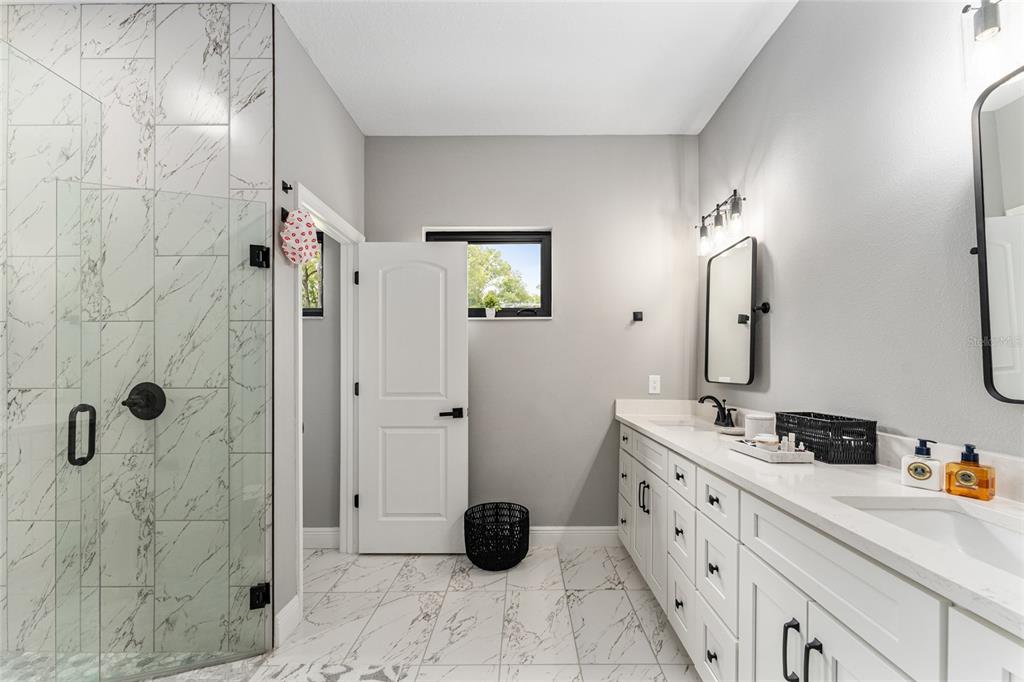 9 Middleground Road Ocala, FL 34482 - Photo 22 of 42 a bathroom with a double vanity sink toilet and shower