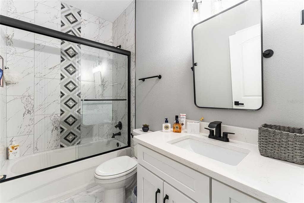 9 Middleground Road Ocala, FL 34482 - Photo 30 of 42 a bathroom with a sink a toilet and a mirror