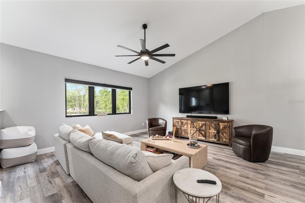 9 Middleground Road Ocala, FL 34482 - Photo 10 of 42 a living room with furniture and a flat screen tv