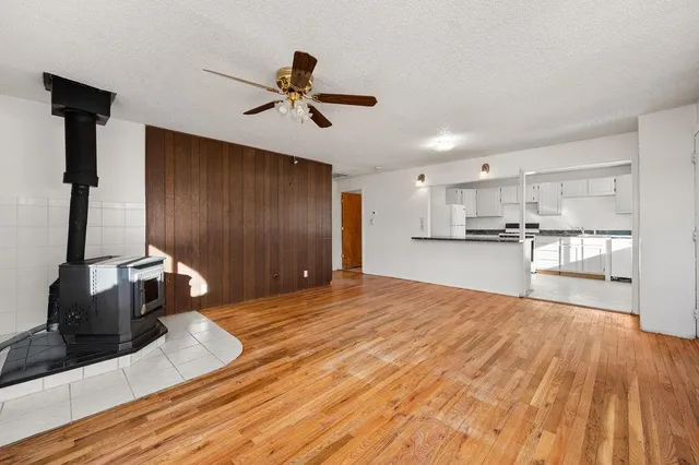 a kitchen with granite countertop white cabinets and white appliances
