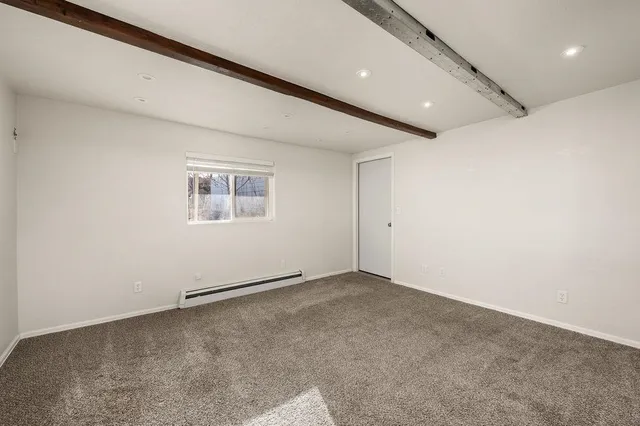 an empty room with a empty space and windows