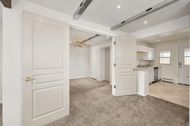 an empty room with windows and closet