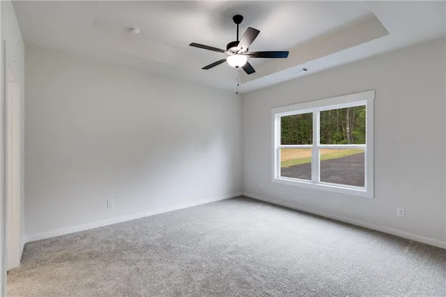 a view of a livingroom with a ceiling fan and window