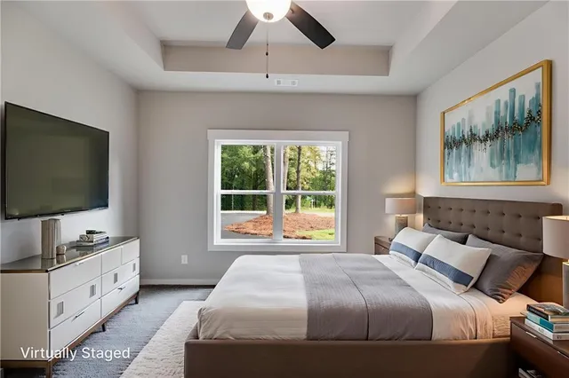 a bedroom with a bed and a flat tv screen on dresser