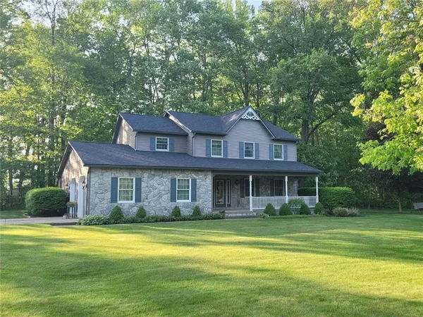 a front view of a house with a garden