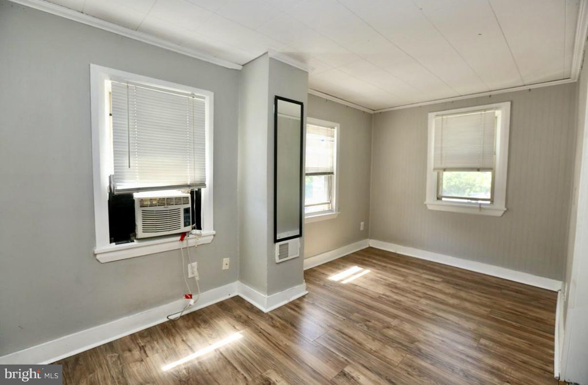 310 Ellis Street Glassboro, NJ 08028 - Photo 7 of 15 an empty room with wooden floor and windows