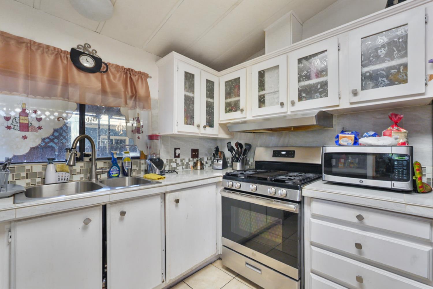 4837 Faith Home Road, Unit 102 Ceres, CA 95307 - Photo 7 of 16 a kitchen with stainless steel appliances granite countertop a stove and cabinets