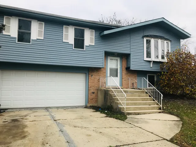 a front view of a house with stairs