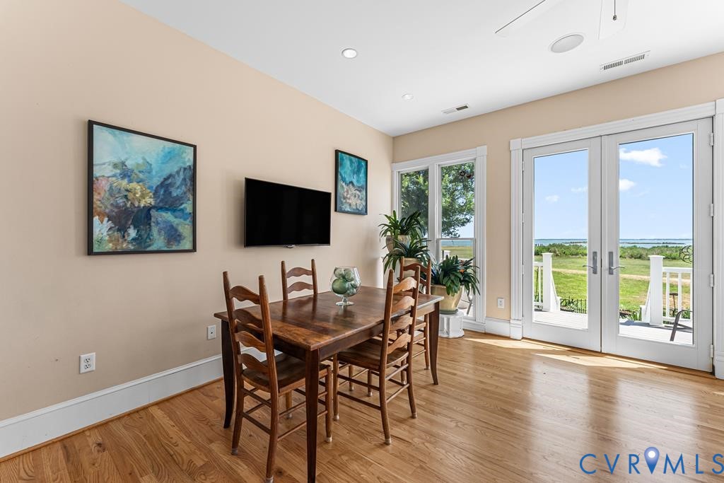 2414 Windmill Point Road White Stone, VA 22578 - Photo 23 of 72 a view of a dining room with furniture window and wooden floor