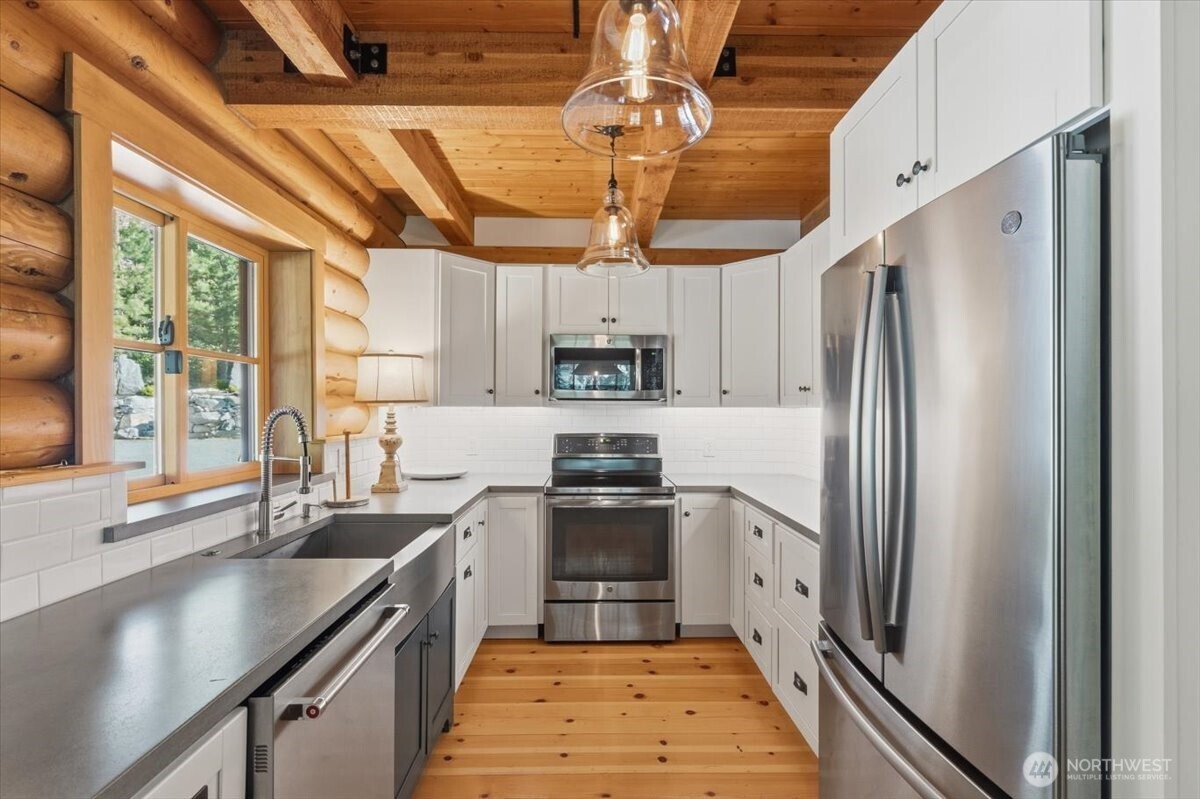 2250 First Crk Road Chelan, WA 98816 - Photo 13 of 39 a kitchen with stainless steel appliances granite countertop a sink a stove and a refrigerator