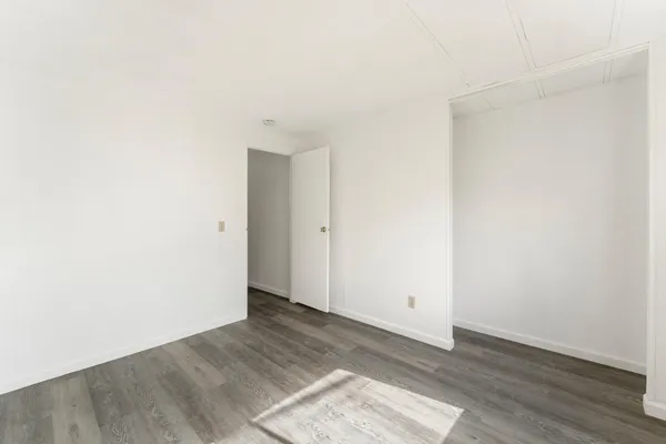 an empty room with wooden floor