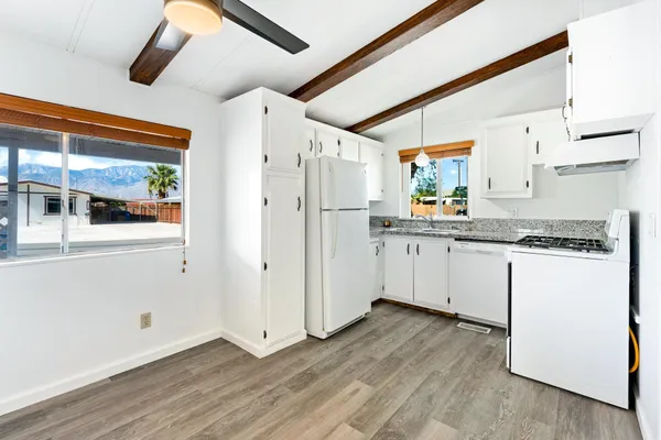 a kitchen with a refrigerator a sink and cabinets