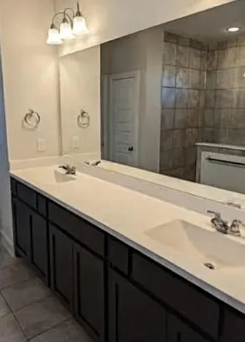 a bathroom with a sink double vanity and a mirror