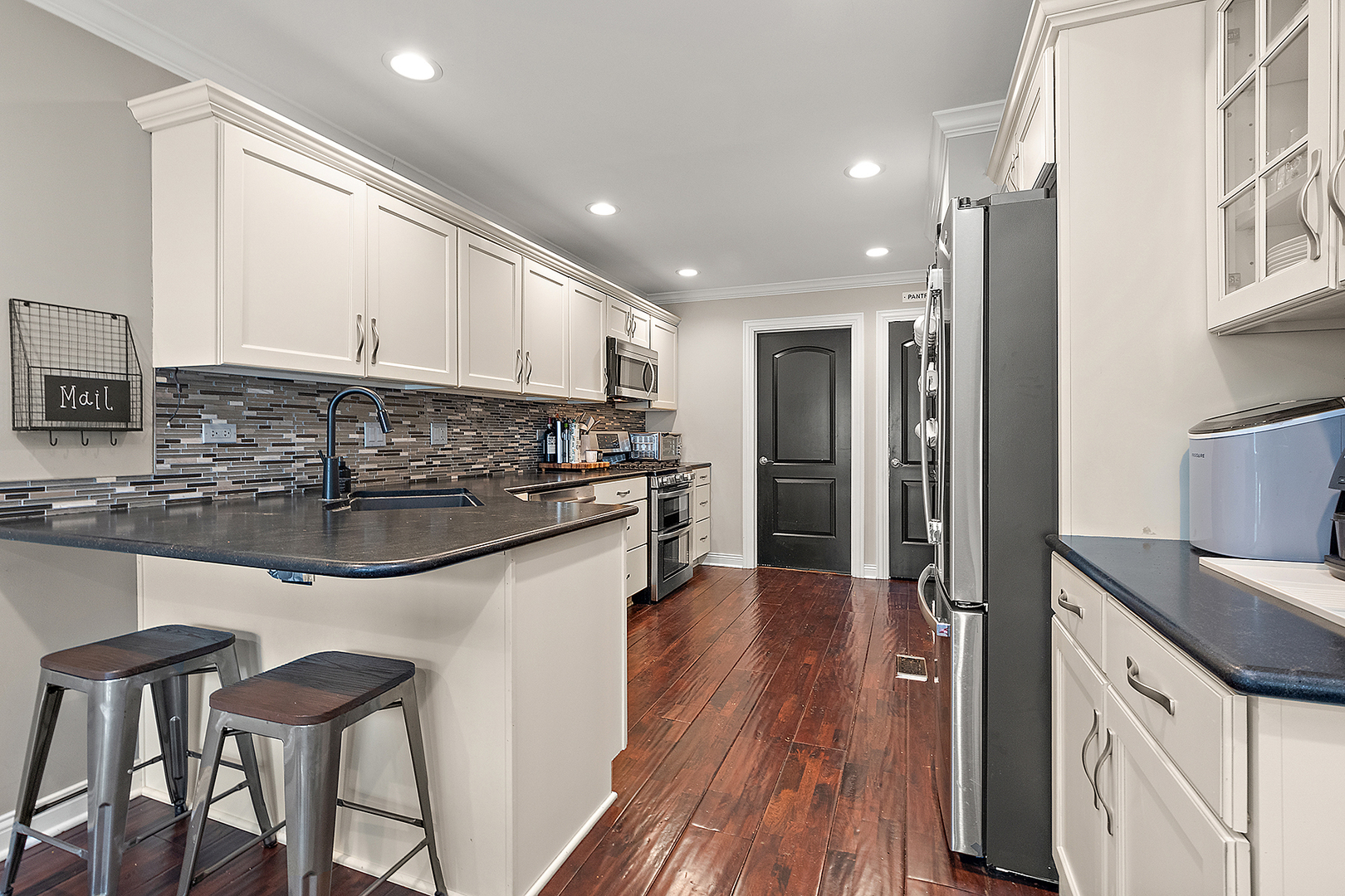 8237 Pecan Place Frankfort, IL 60423 - Photo 11 of 39 a kitchen with stainless steel appliances granite countertop a refrigerator a sink dishwasher a stove and white countertops with wooden floor