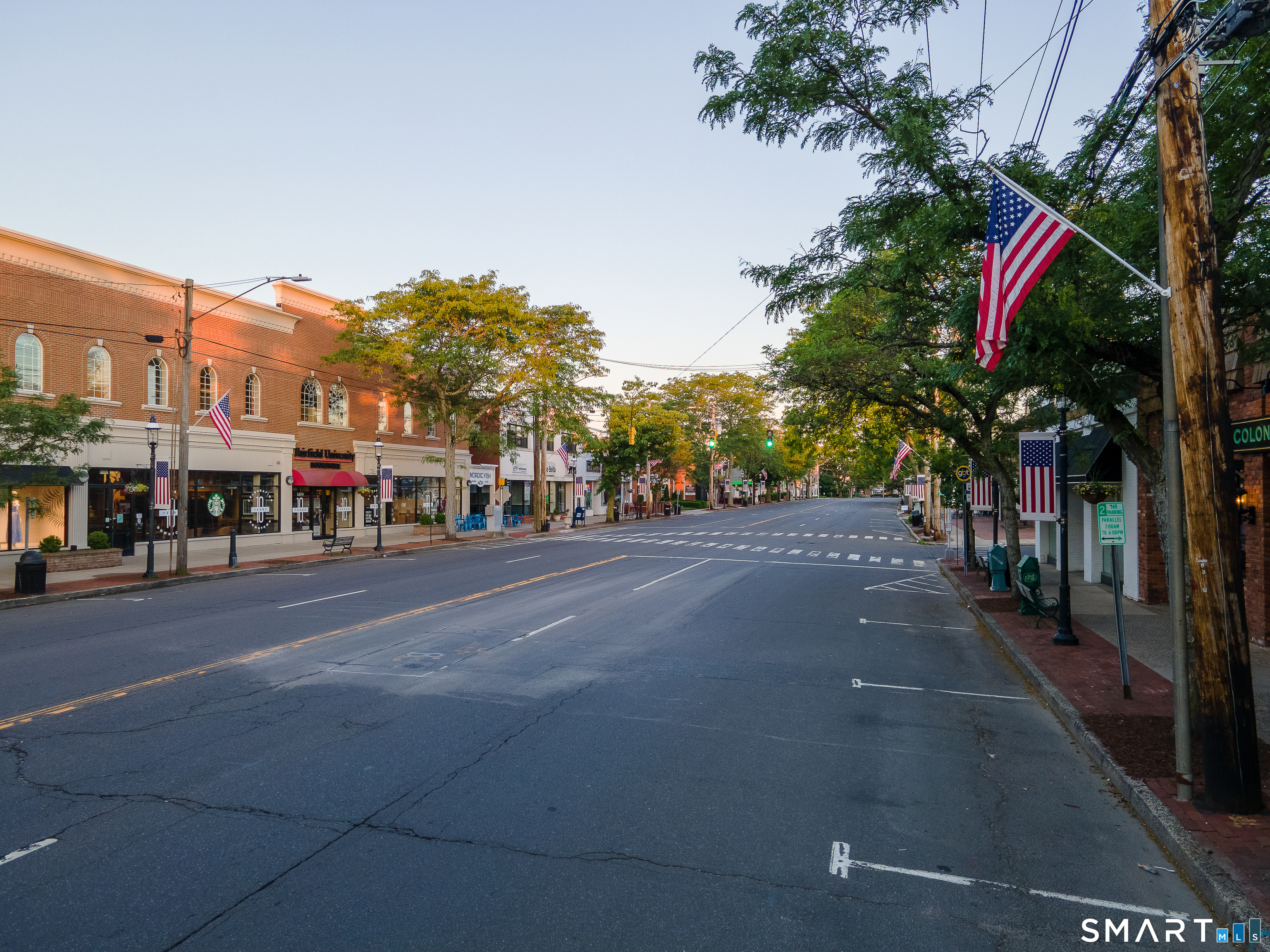 345 Reef Road, Unit C9 Fairfield, CT 06824 - Photo 22 of 32 a city street with a building and trees in the background