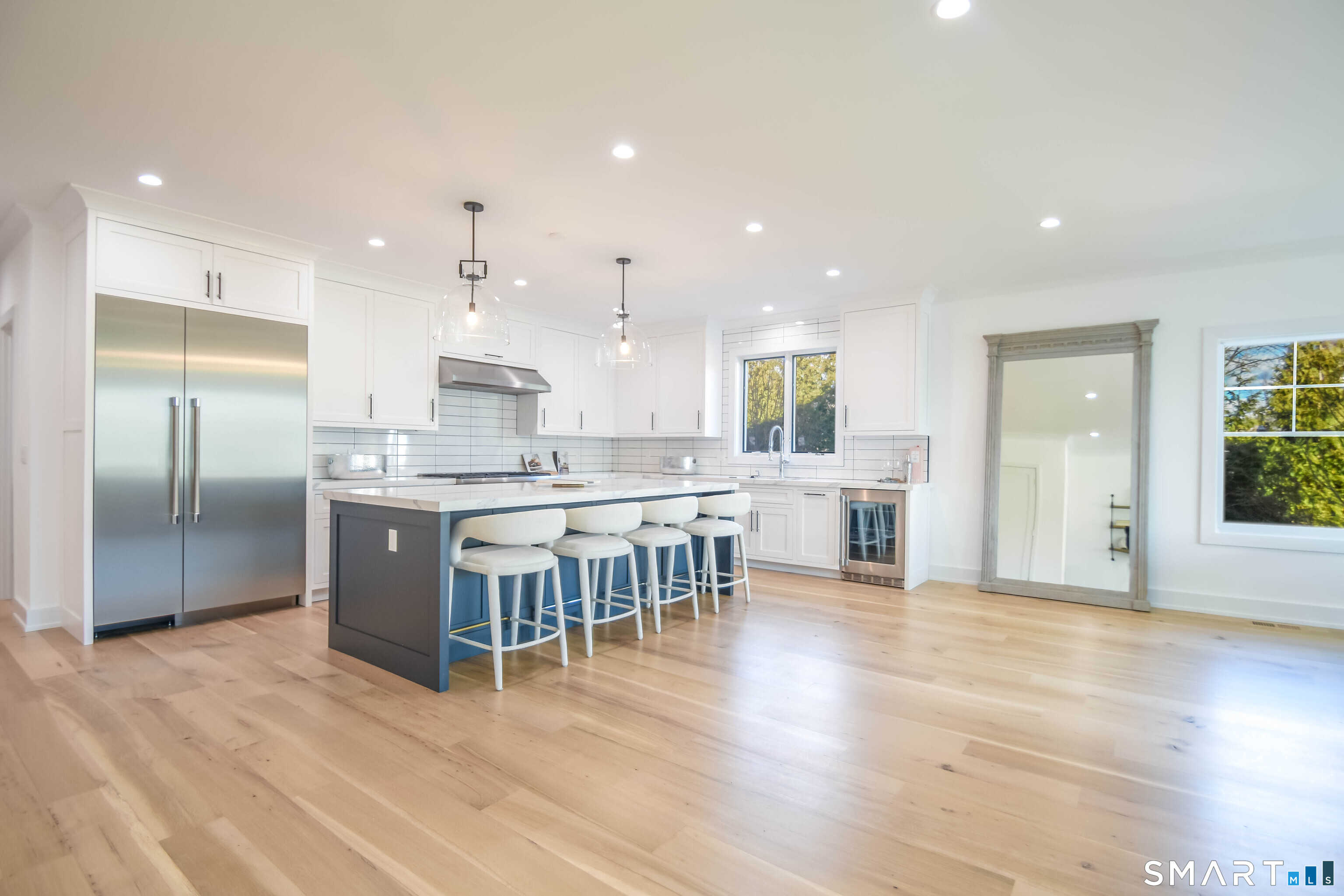 345 Reef Road, Unit C9 Fairfield, CT 06824 - Photo 26 of 32 an open kitchen with kitchen island white cabinets and stainless steel appliances