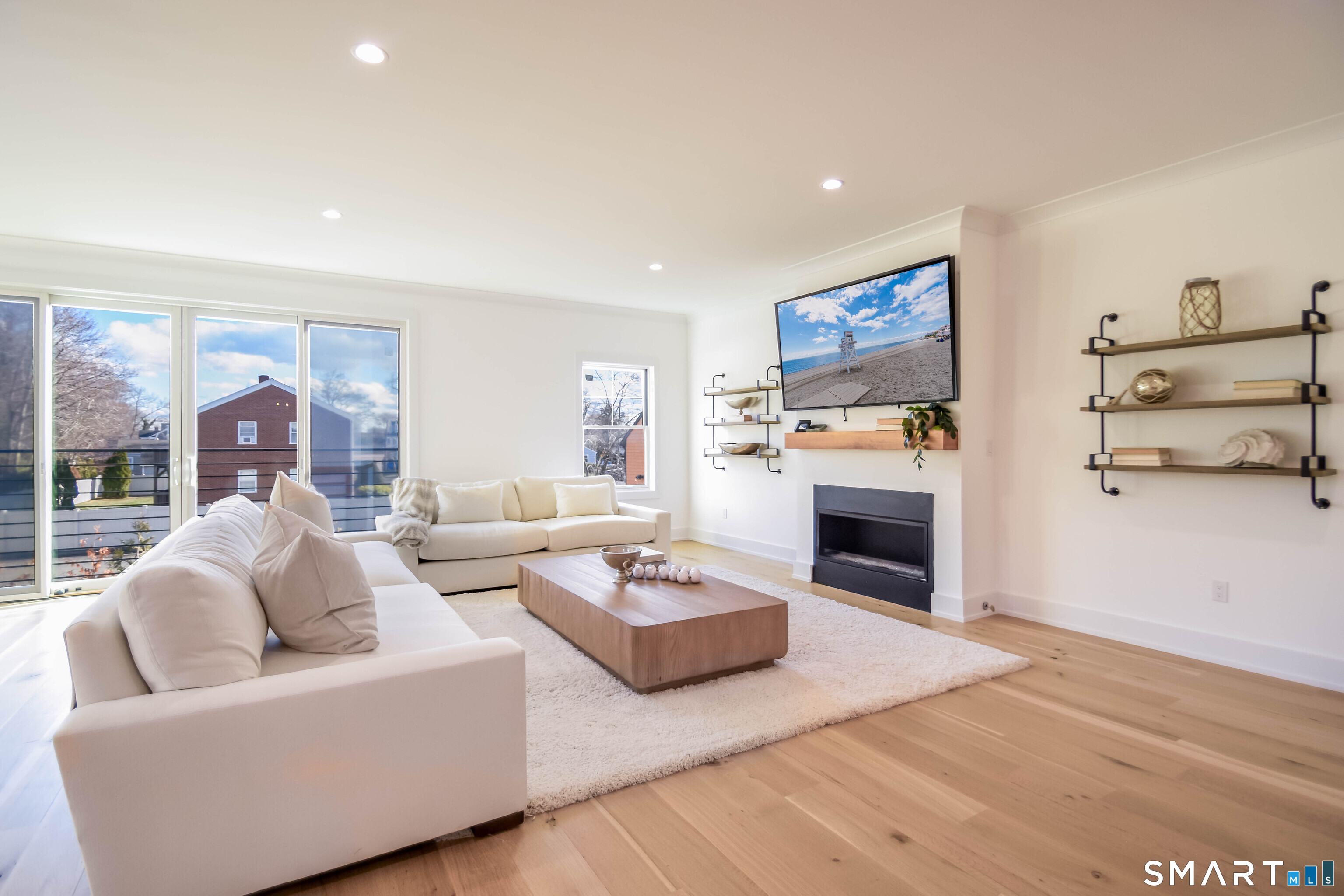 345 Reef Road, Unit C9 Fairfield, CT 06824 - Photo 29 of 32 a living room with fireplace furniture and a wooden floor