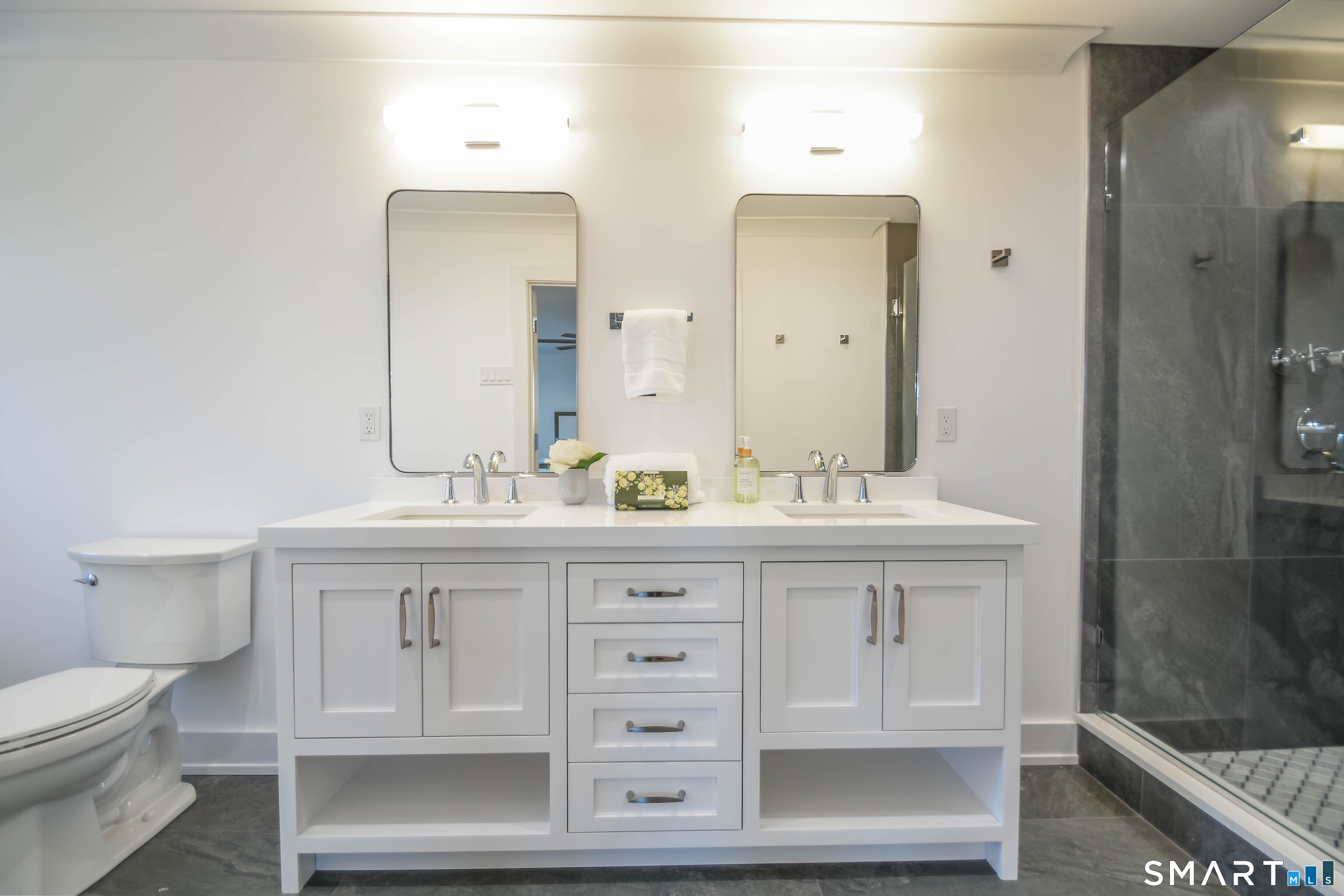 345 Reef Road, Unit C9 Fairfield, CT 06824 - Photo 4 of 32 a bathroom with a sink a toilet and a mirror