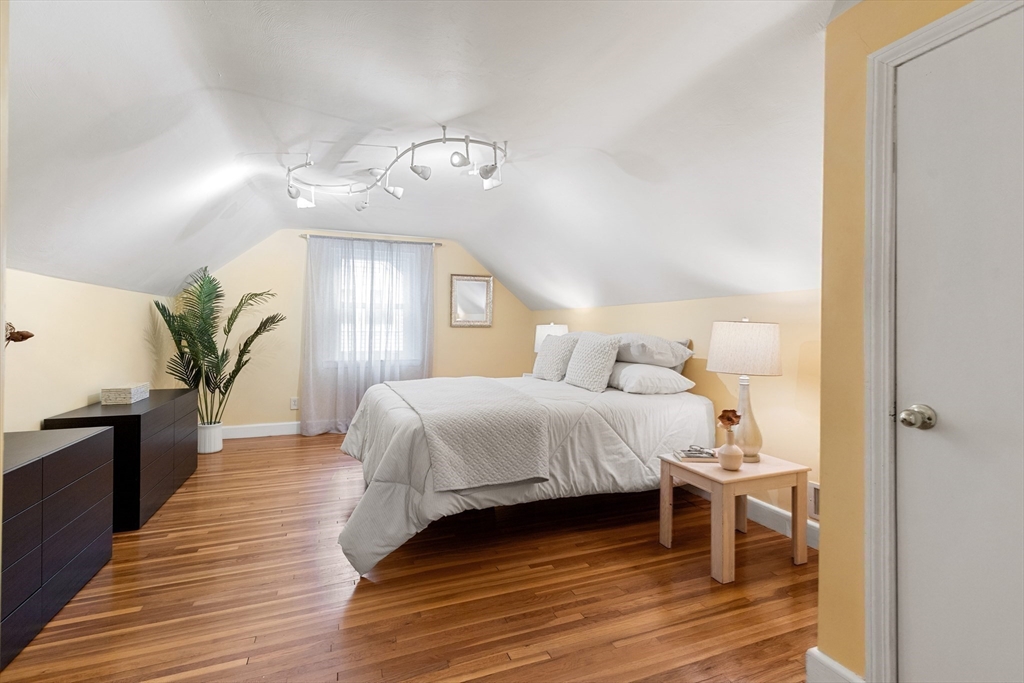 44 Westlund Road Belmont, MA 02478 - Photo 4 of 30 a bedroom with a bed and wooden floor