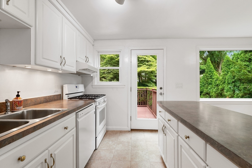 44 Westlund Road Belmont, MA 02478 - Photo 6 of 30 a kitchen with stainless steel appliances granite countertop a sink and a white cabinets