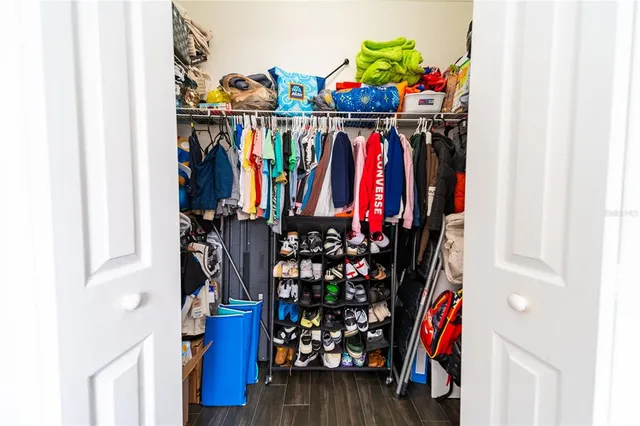 a view of walk in closet with clothes