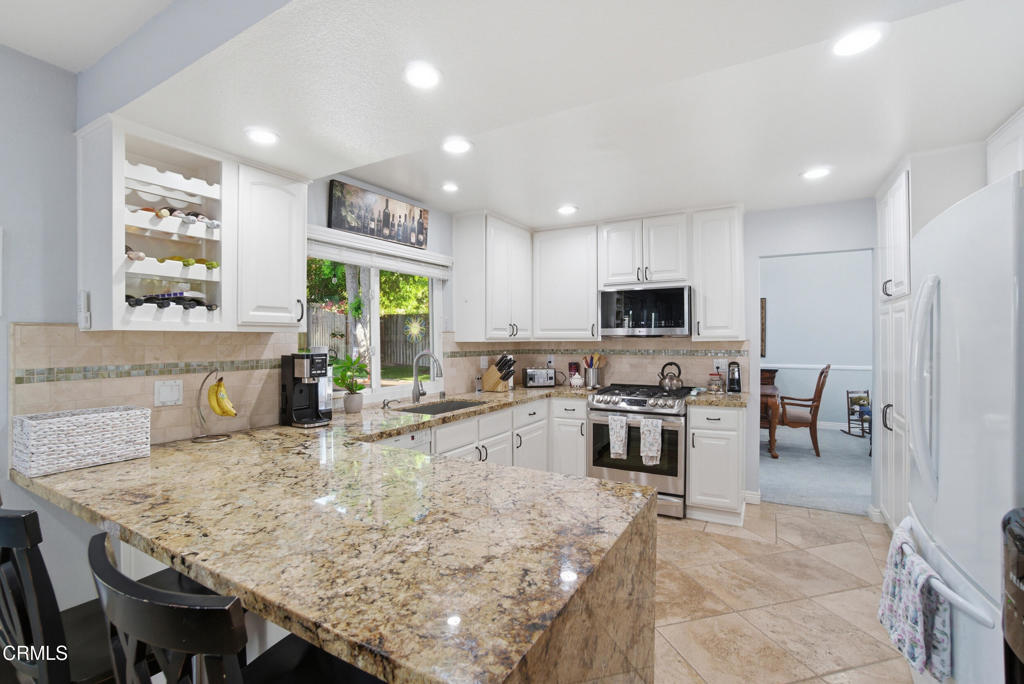 1288 Old Ranch Road Camarillo, CA 93012 - Photo 12 of 61 a kitchen with stainless steel appliances granite countertop a stove top oven a sink a counter top space and cabinets