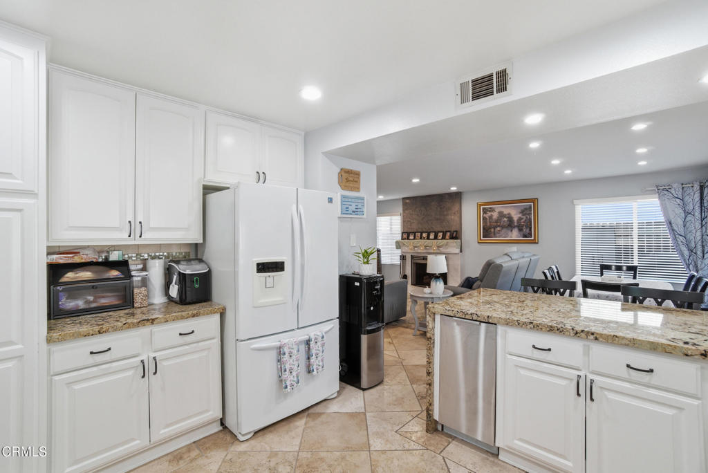 1288 Old Ranch Road Camarillo, CA 93012 - Photo 13 of 61 a kitchen with white cabinets and refrigerator