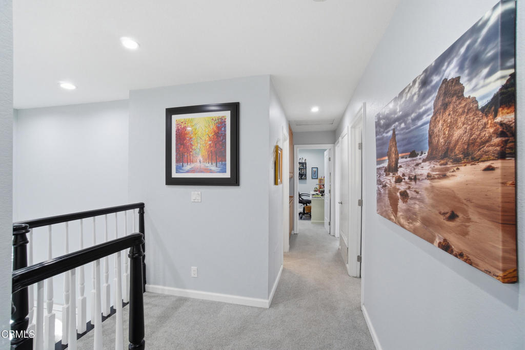 1288 Old Ranch Road Camarillo, CA 93012 - Photo 22 of 61 a view of a hallway with paintings on the wall
