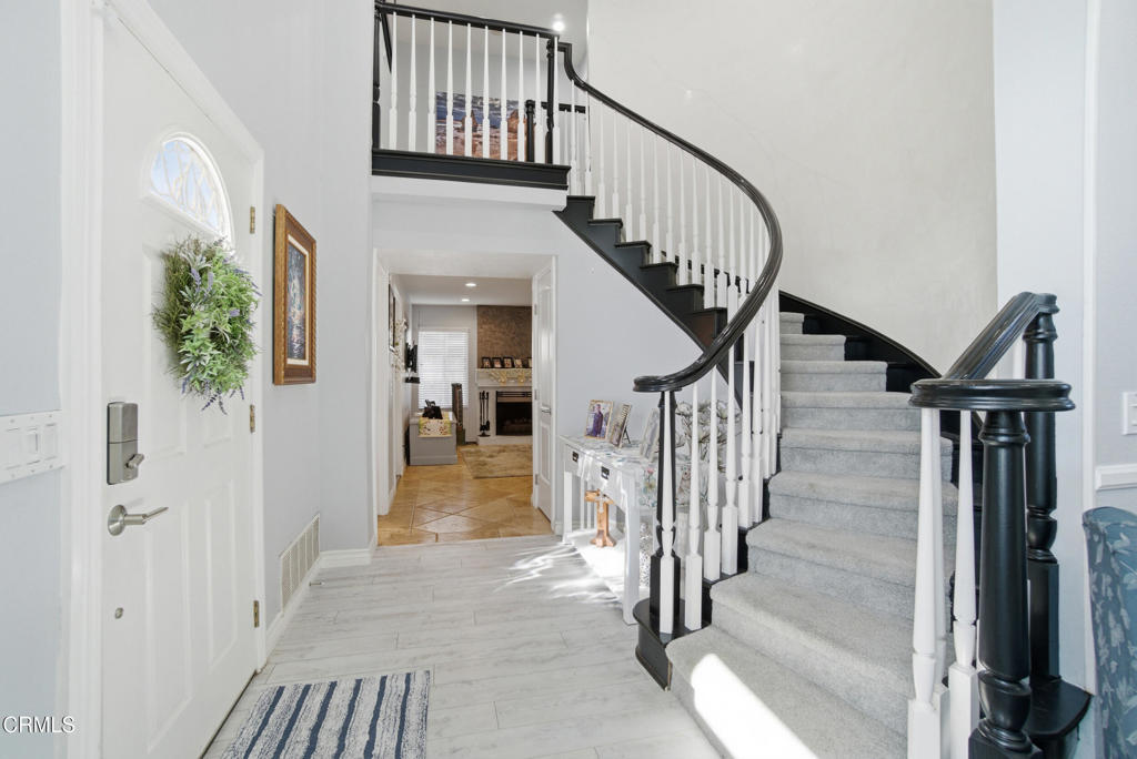 1288 Old Ranch Road Camarillo, CA 93012 - Photo 4 of 61 a view of staircase with lots of frames on wall and windows