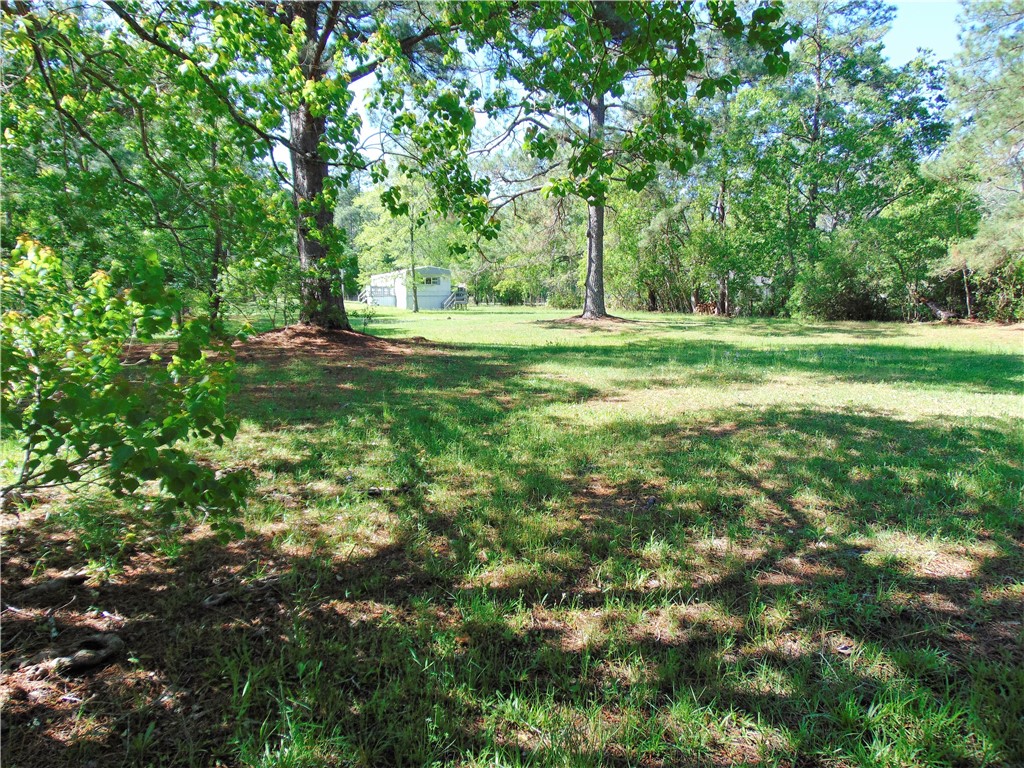 54281 Roy Booth Road Callahan, FL 32011 - Photo 3 of 8 a view of outdoor space with deck and yard