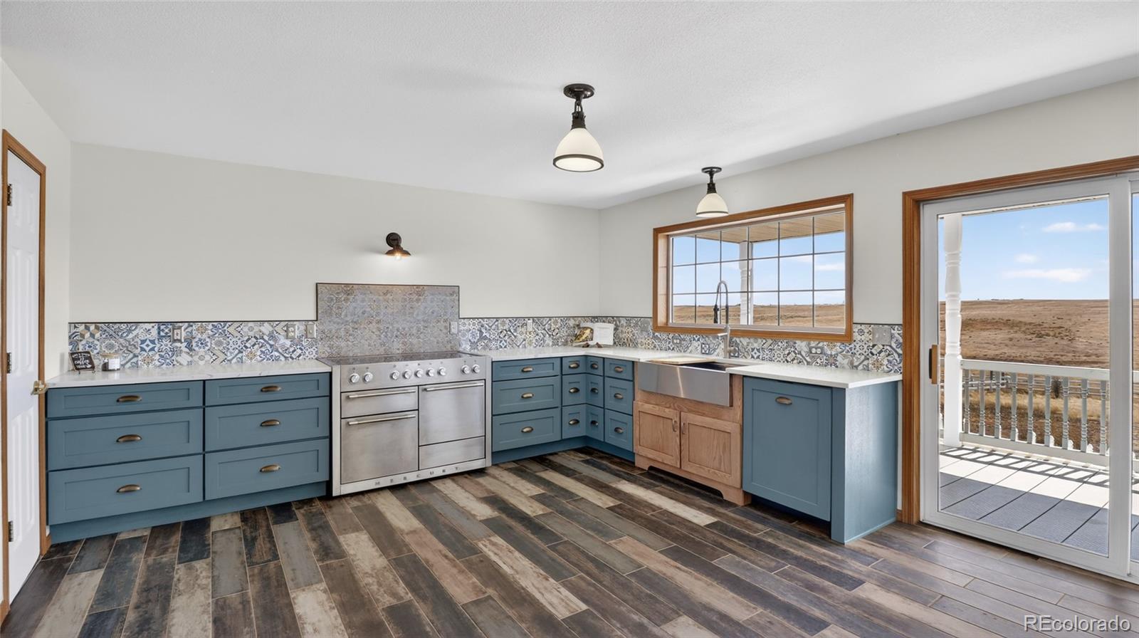 44166 East Iliff Trail Bennett, CO 80102 - Photo 11 of 50 a kitchen with granite countertop cabinets a sink and appliances