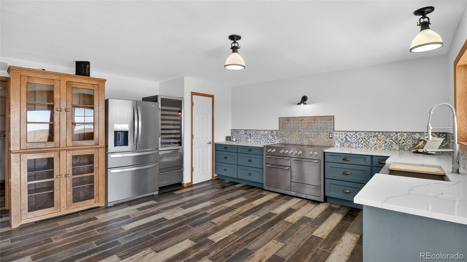 44166 East Iliff Trail Bennett, CO 80102 - Photo 12 of 50 a kitchen with a refrigerator stove and sink
