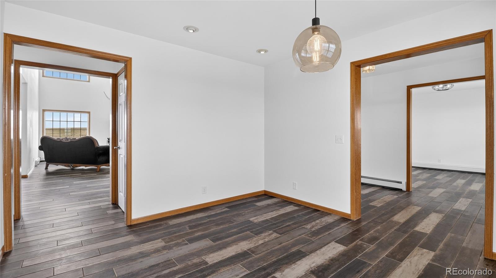 44166 East Iliff Trail Bennett, CO 80102 - Photo 15 of 50 a view of a hallway view with wooden floor and workspace