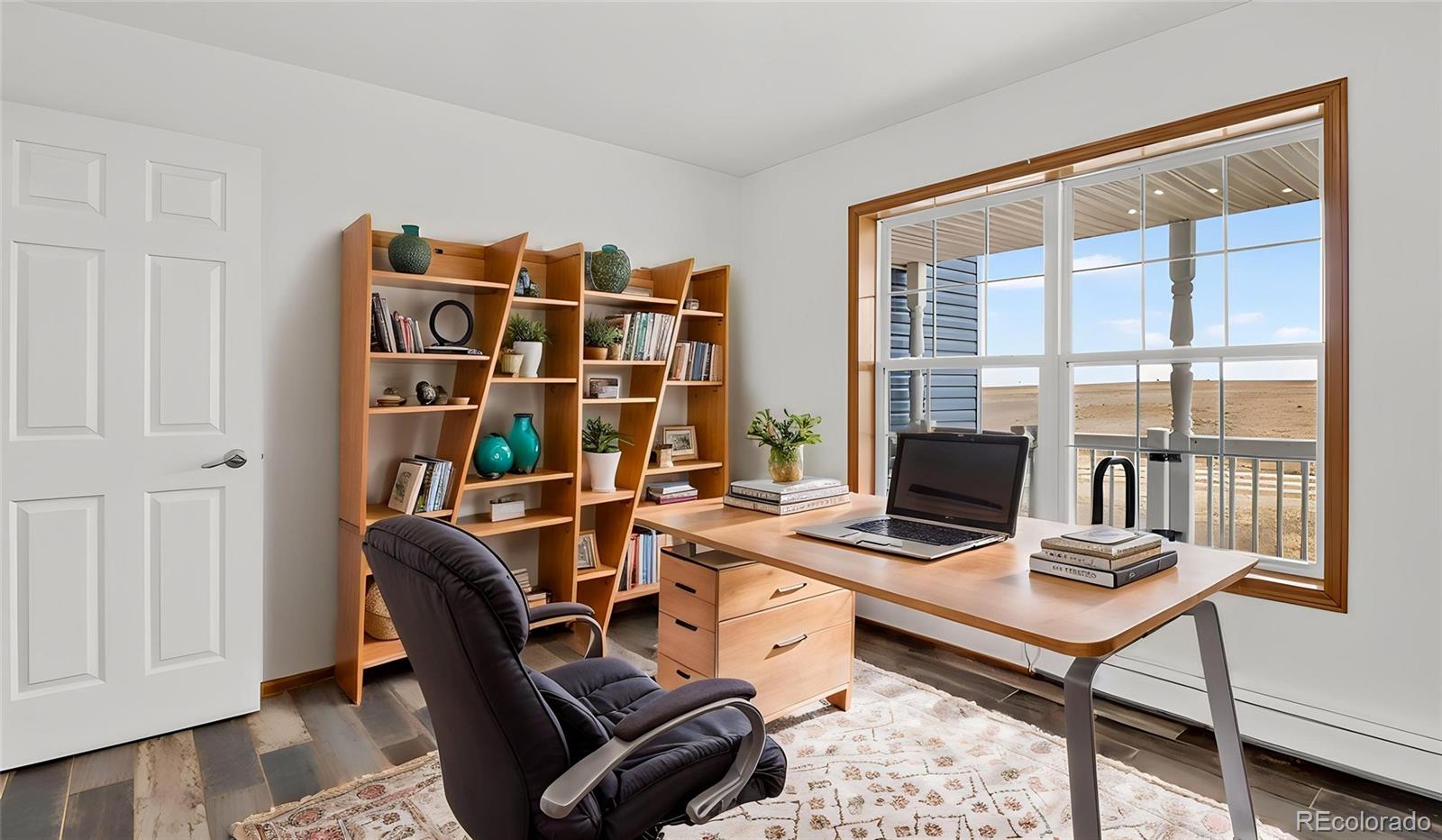 44166 East Iliff Trail Bennett, CO 80102 - Photo 18 of 50 a view of a workspace with furniture and a window
