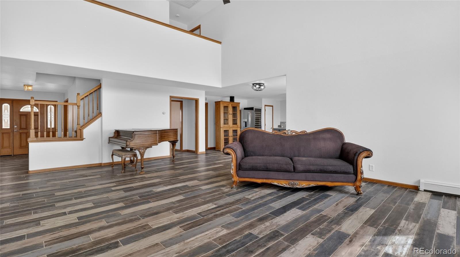 44166 East Iliff Trail Bennett, CO 80102 - Photo 22 of 50 a living room with furniture and a wooden floor