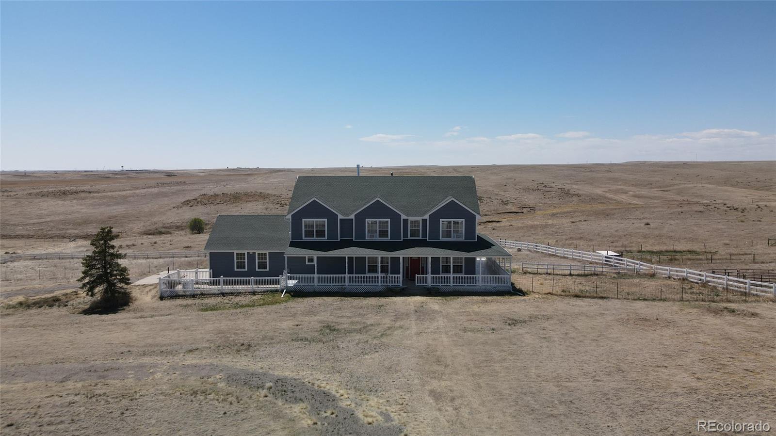 44166 East Iliff Trail Bennett, CO 80102 - Photo 3 of 50 a front view of a house with a yard