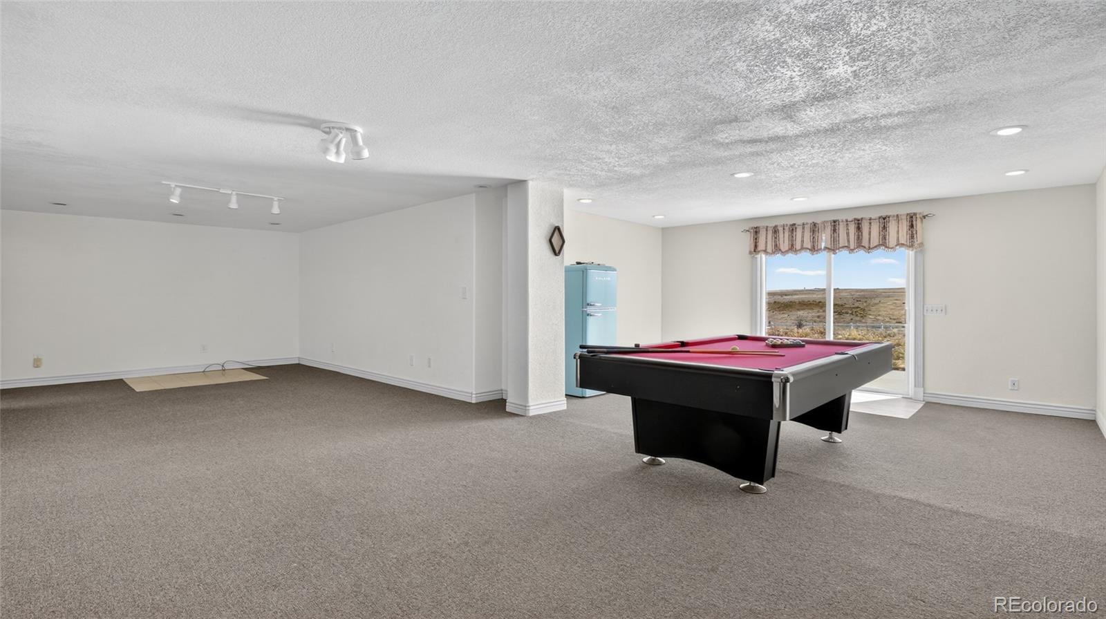 44166 East Iliff Trail Bennett, CO 80102 - Photo 33 of 50 a room with pool table and window