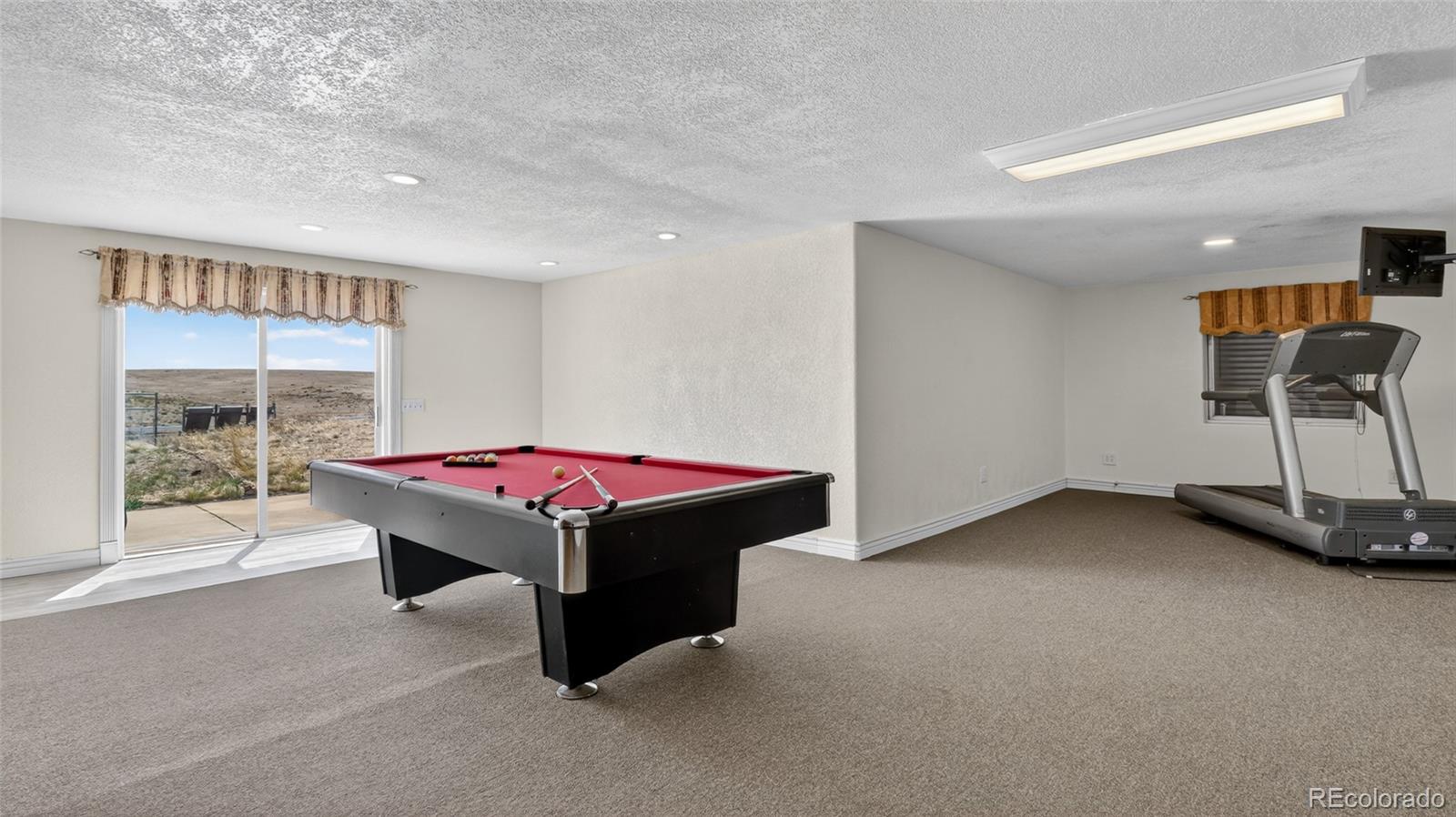 44166 East Iliff Trail Bennett, CO 80102 - Photo 34 of 50 a room with pool table and windows
