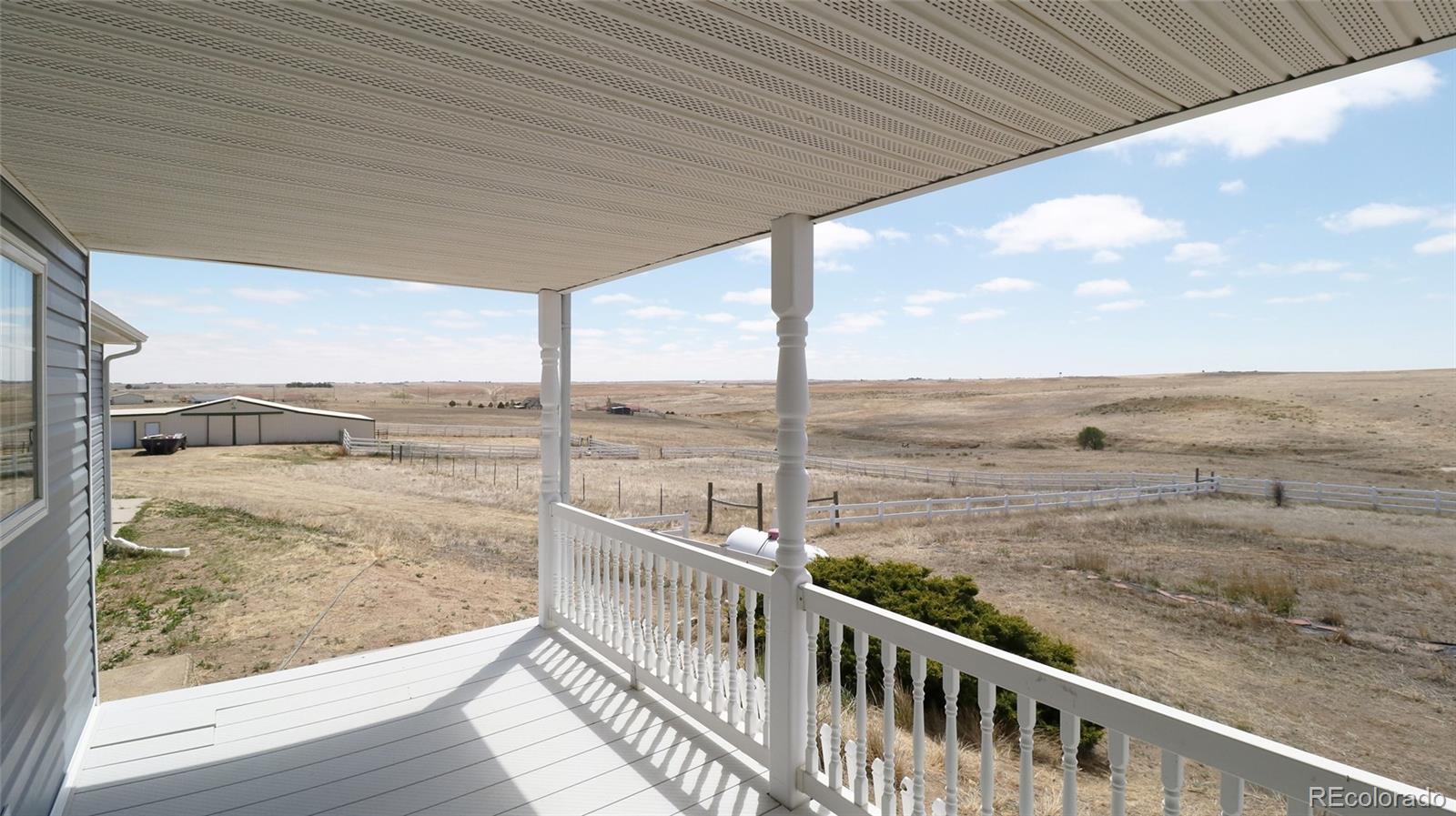 44166 East Iliff Trail Bennett, CO 80102 - Photo 44 of 50 a view of a balcony with an ocean view