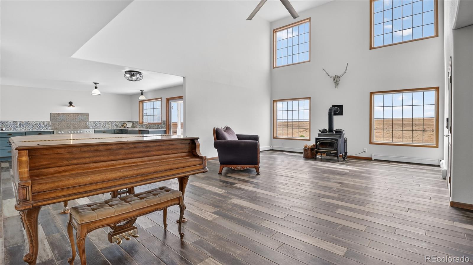 44166 East Iliff Trail Bennett, CO 80102 - Photo 9 of 50 a living room with furniture and a wooden floor
