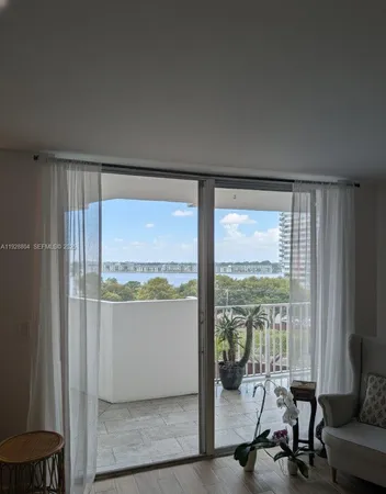 a view of a room with gym equipment and floor to ceiling window