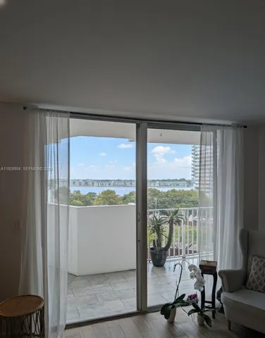 a view of a room with gym equipment and floor to ceiling window