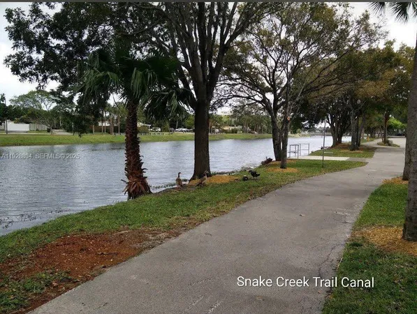 a view of a park with large trees