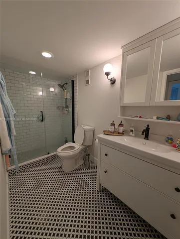 a bathroom with a double vanity sink mirror and toilet