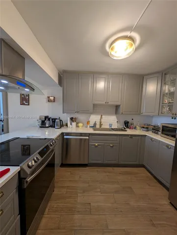 a kitchen with stainless steel appliances granite countertop a stove a sink dishwasher and a refrigerator