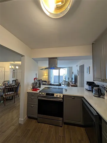 a kitchen with a stove and a wooden floors