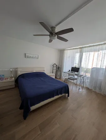 a spacious bedroom with a bed and window