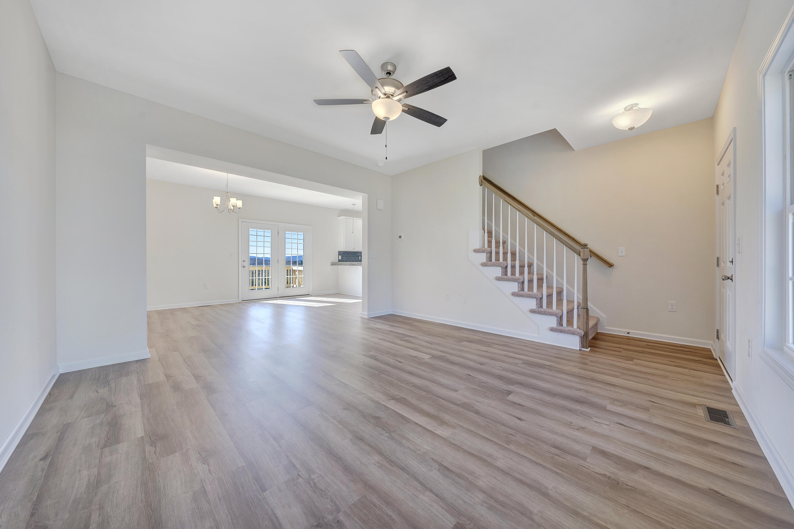 3076 Isabel Lane Salem, VA 24153 - Photo 2 of 16 a view of an empty room with wooden floor and a ceiling fan