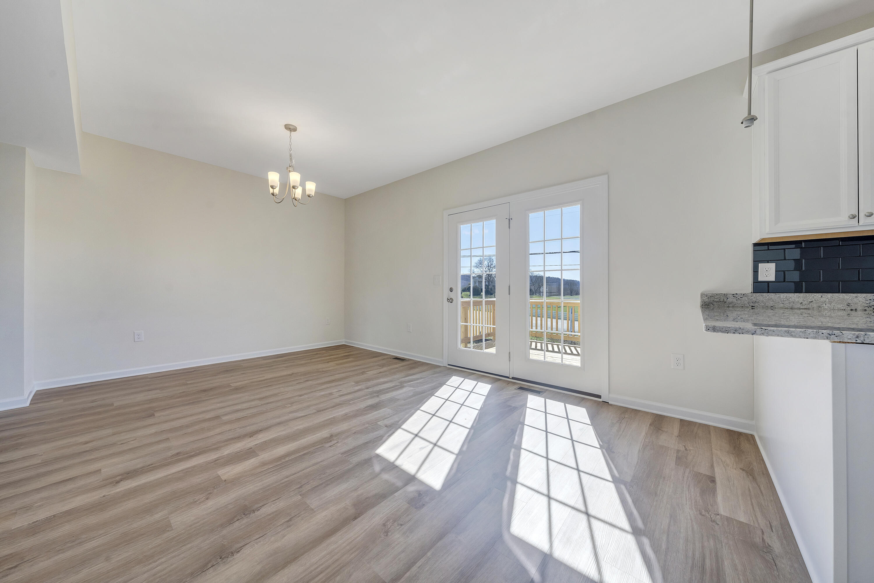 3076 Isabel Lane Salem, VA 24153 - Photo 5 of 16 a view of an empty room with wooden floor and a window